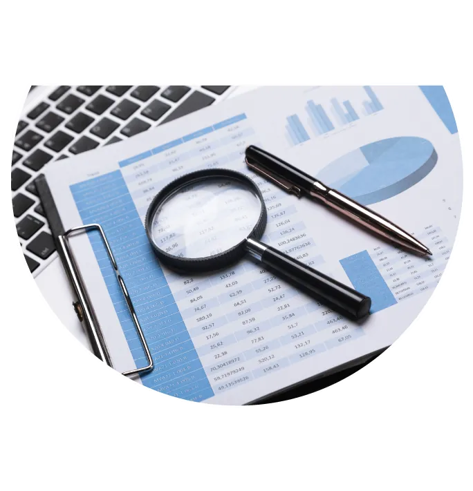 Stocks Detail Sheet with Magnifying glass and pen